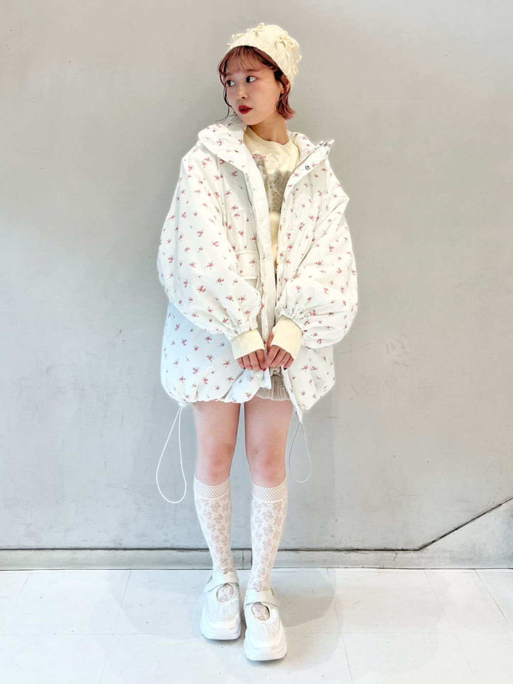 ピンク系のブルゾン、ベージュ系のスウェットパンツ、ホワイト系のニット/セーターを着用したレディースの冬コーディネートの6枚目の写真