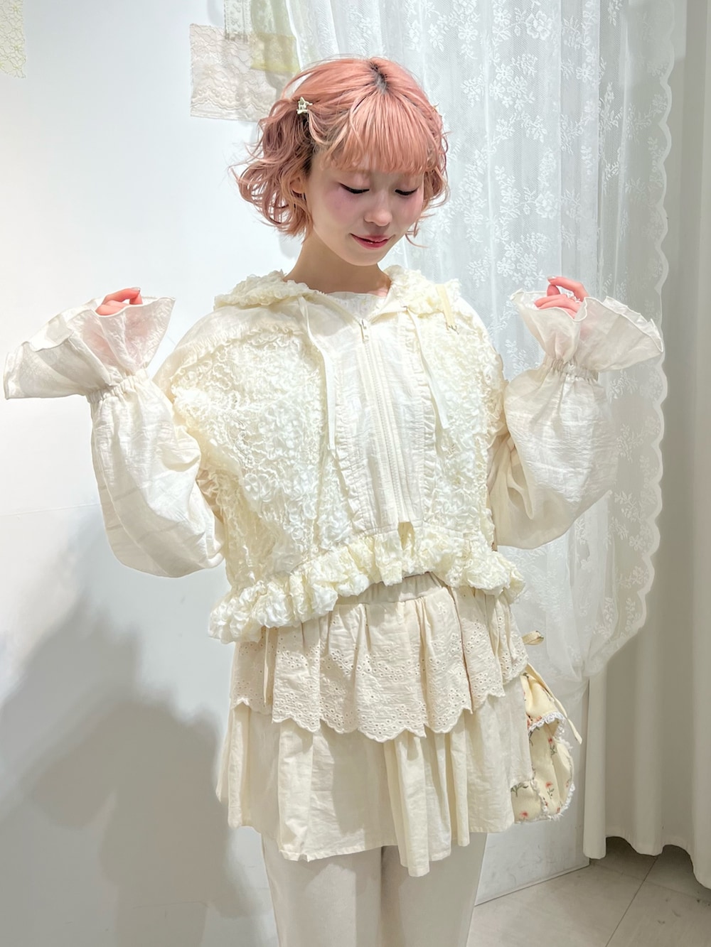 ホワイト系のスニーカー、ホワイト系のスウェットパンツ、ホワイト系のショルダーバッグを着用したレディースの冬コーディネートの6枚目の写真