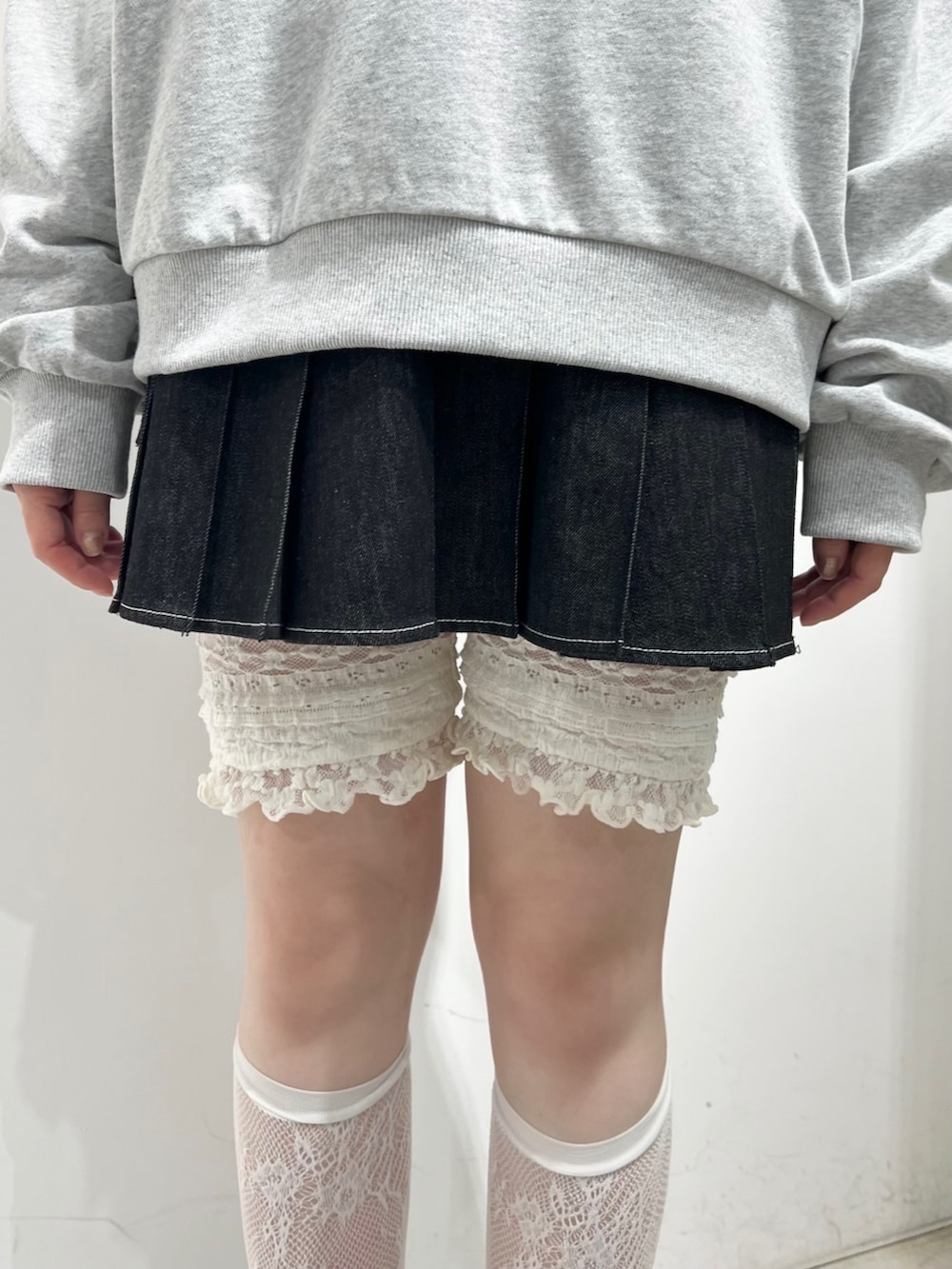 グレー系のスウェット、ブラック系のスカート、ブラック系のローファーを着用したレディースの秋コーディネートの9枚目の写真