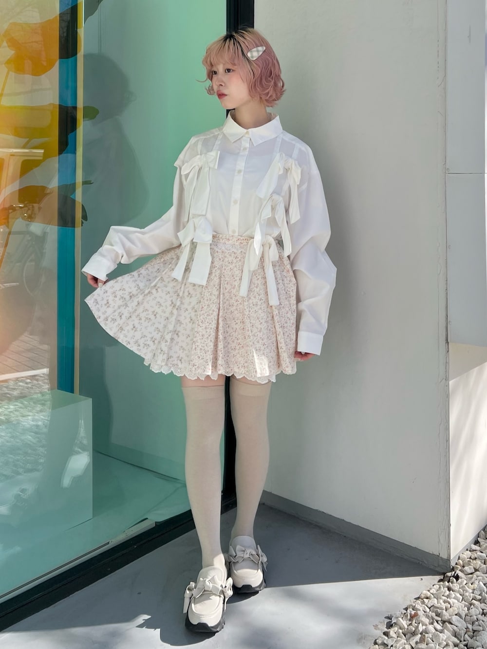 ホワイト系のシャツ/ブラウス、ピンク系のスカート、ホワイト系のスニーカーを着用したレディースの冬コーディネートの6枚目の写真