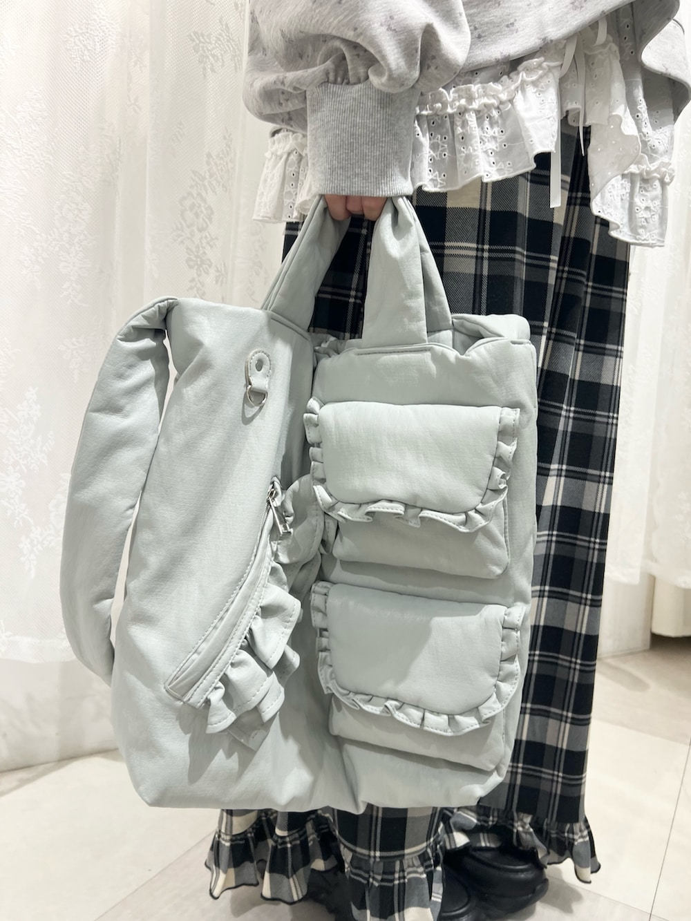 グレー系のスウェット、ベージュ系のスカート、ブラック系のスニーカーを着用したレディースの冬コーディネートの10枚目の写真