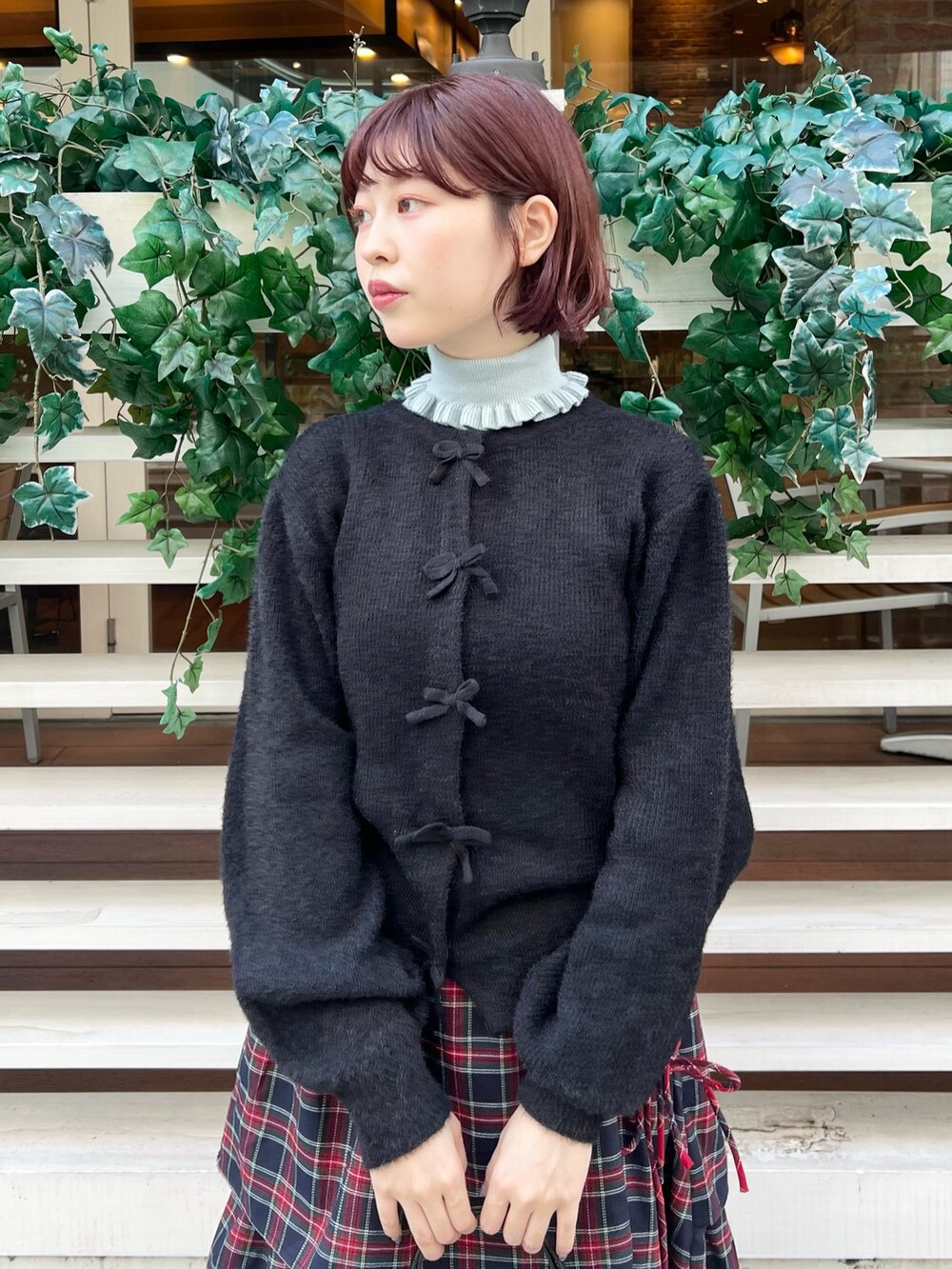 ブルー系のニット/セーター、ブルー系のスカート、ブラック系のスニーカーを着用したレディースの秋コーディネートの4枚目の写真