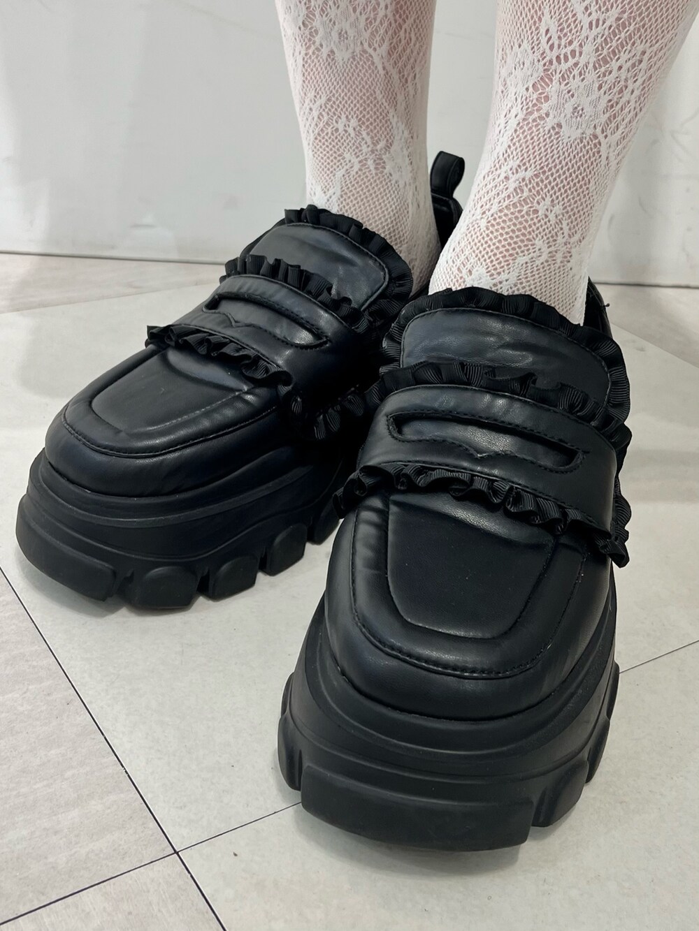 レッド系のカーディガン/ボレロ、ゴールド系のシャツ/ブラウス、ブラック系のスカートを着用したレディースの秋コーディネートの8枚目の写真