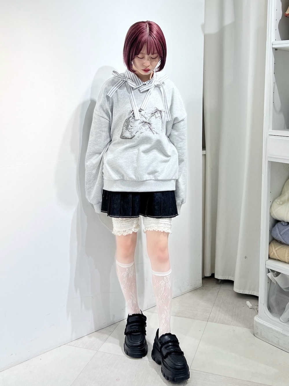 グレー系のスウェット、ブラック系のスカート、ブラック系のローファーを着用したレディースの秋コーディネートの4枚目の写真