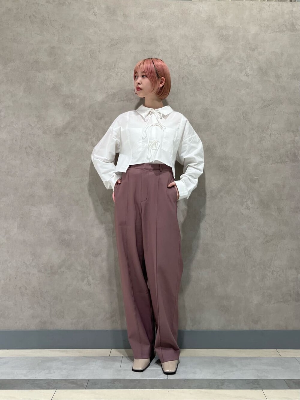 ホワイト系のシャツ/ブラウス、ピンク系のスラックス、ベージュ系のブーツを着用したレディースの秋コーディネートの5枚目の写真