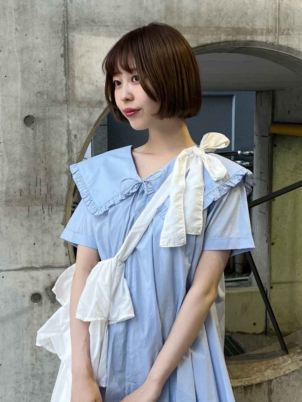 ホワイト系のトートバッグ、ブルー系のスニーカー、ブルー系のその他パンツを着用したレディースの春コーディネートの3枚目の写真