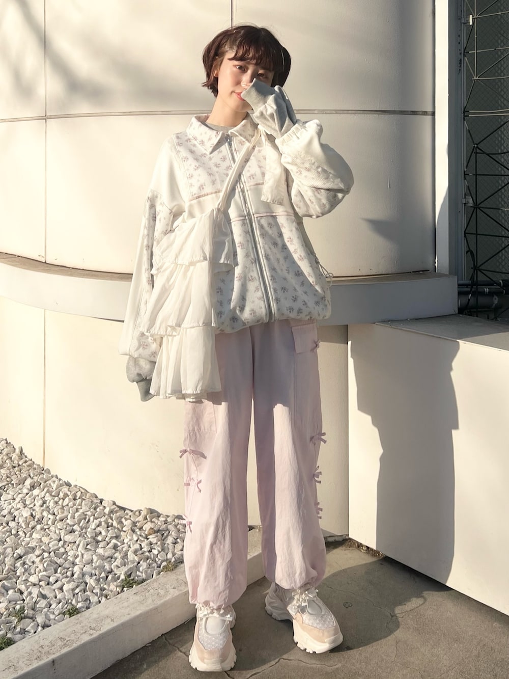 ピンク系のジャージ、ピンク系のカーゴパンツ、ピンク系のスニーカーを着用したレディースの冬コーディネートの3枚目の写真