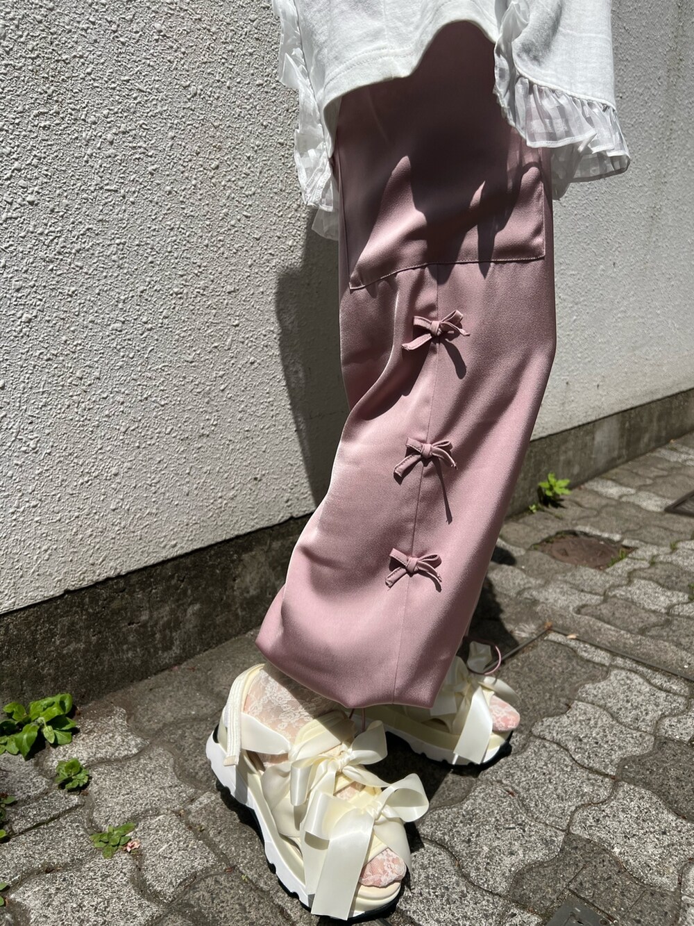 ピンク系のカーゴパンツ、ホワイト系のTシャツ/カットソー、ホワイト系のサンダルを着用したレディースの春コーディネートの4枚目の写真