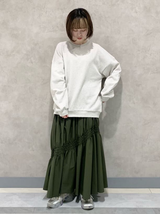 ベージュ系のスカート、ホワイト系のスニーカー、ホワイト系のスウェットを着用したレディースの冬コーディネートの4枚目の写真