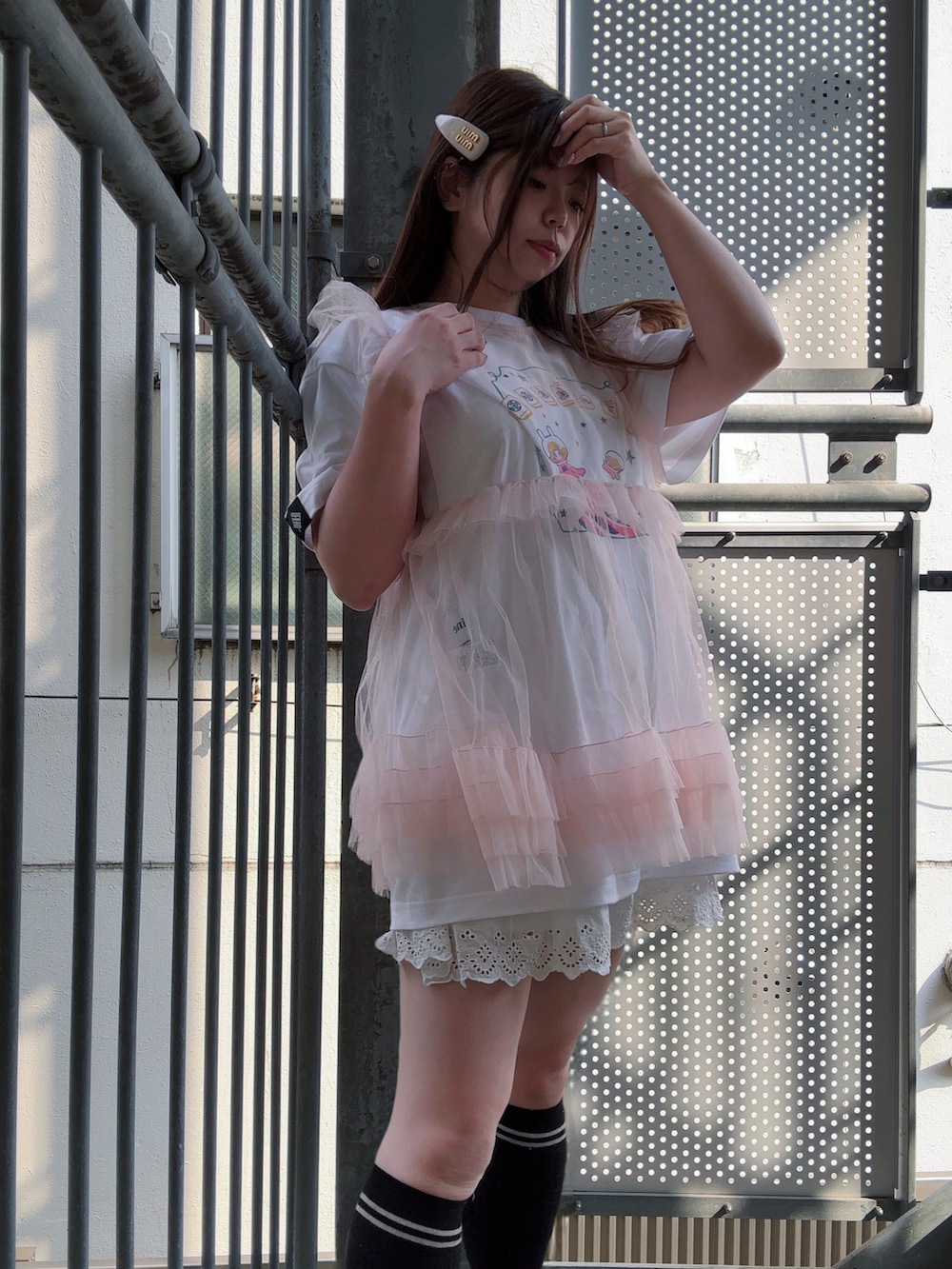 ピンク系のトップス、ホワイト系のTシャツ/カットソー、ホワイト系のスカートを着用したレディースの秋コーディネートの2枚目の写真