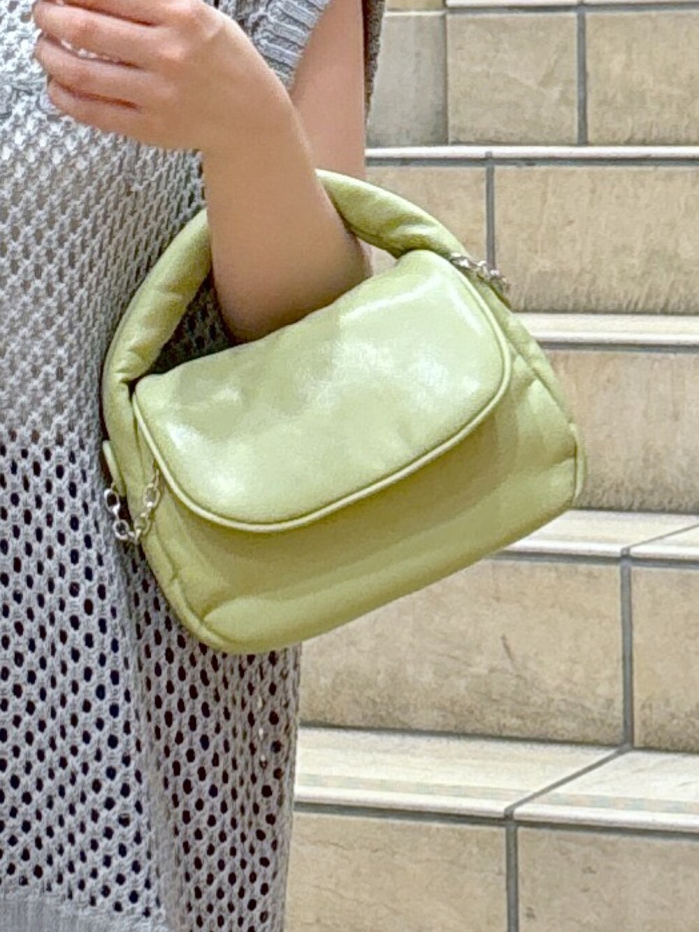 グレー系のニット/セーター、ホワイト系のキャミソール、グリーン系のショルダーバッグを着用したレディースの夏コーディネートの8枚目の写真