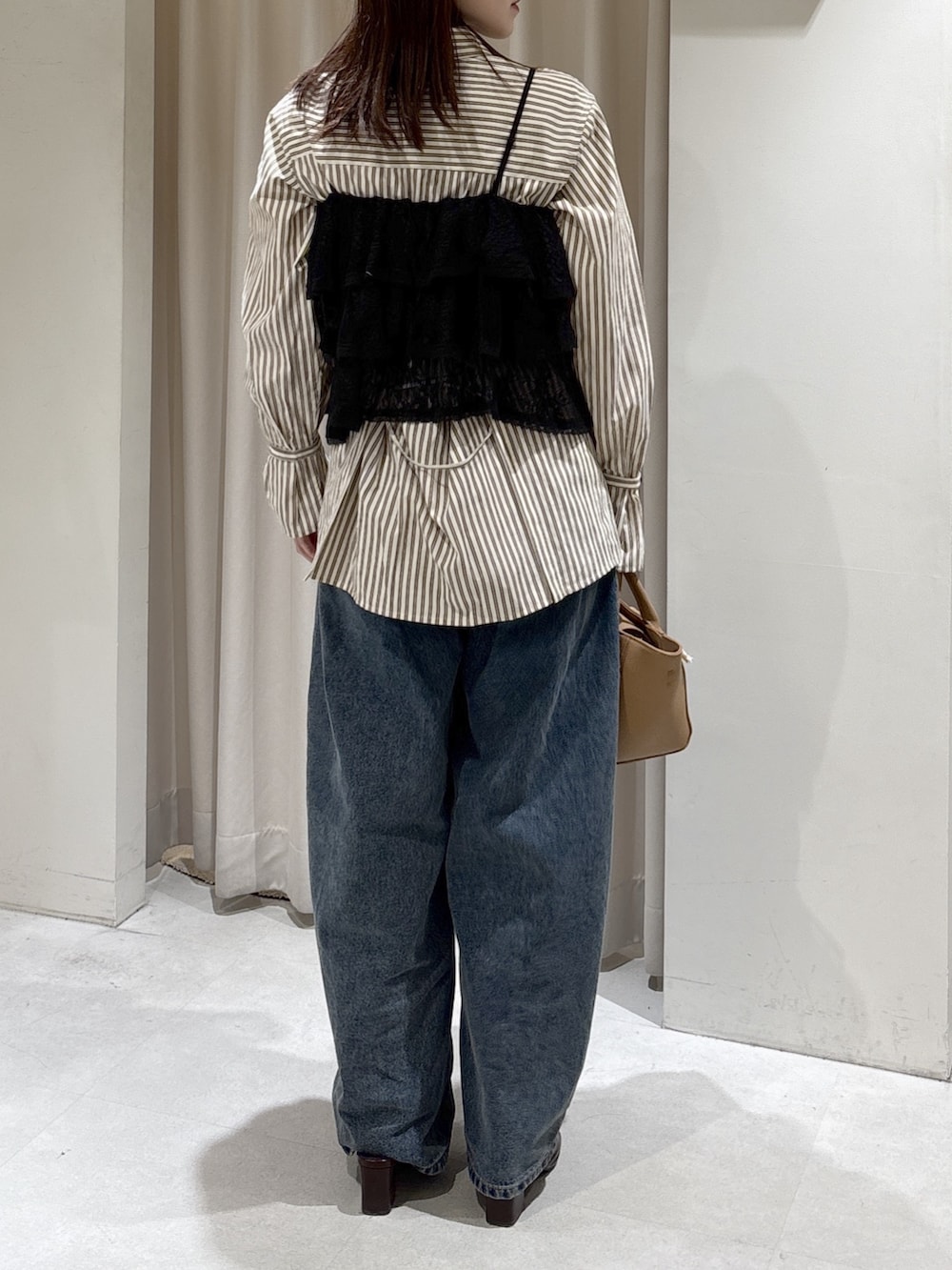 ブラック系のシャツ/ブラウス、ブラウン系のシャツ/ブラウス、ベージュ系のハンドバッグを着用したレディースの冬コーディネートの3枚目の写真