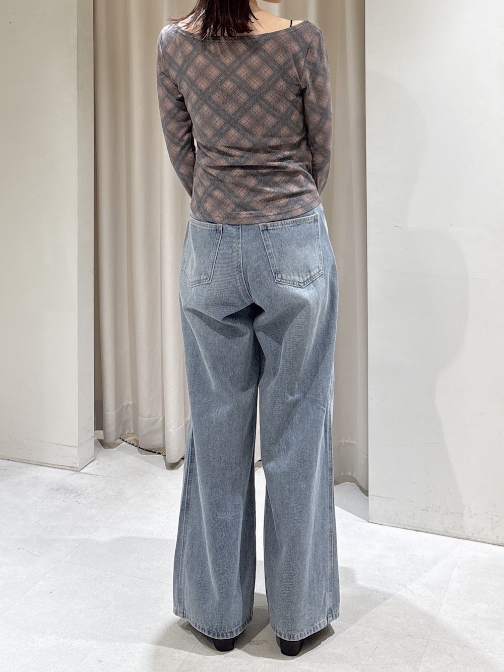 ブラウン系のTシャツ/カットソー、ブルー系のデニムパンツ、ブラウン系のショルダーバッグを着用したレディースの秋コーディネートの3枚目の写真