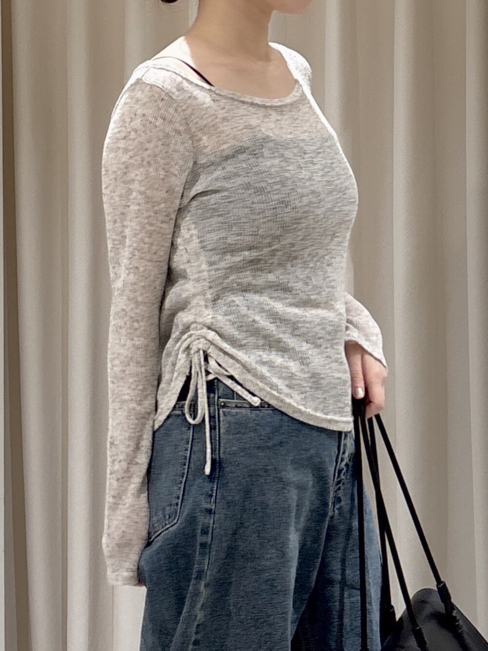 ホワイト系のTシャツ/カットソー、ブラック系のショルダーバッグ、ブルー系のデニムパンツを着用したレディースの冬コーディネートの4枚目の写真