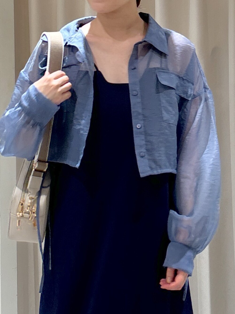 ブルー系のシャツ/ブラウス、ブルー系のワンピース、ホワイト系のボディバッグ/ウエストポーチを着用したレディースの夏コーディネートの4枚目の写真