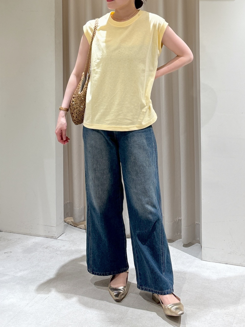 ブラウン系のテーラードジャケット、イエロー系のTシャツ/カットソー、ブルー系のデニムパンツを着用したレディースの春コーディネートの5枚目の写真