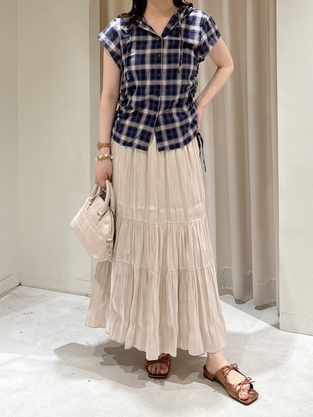 ブルー系のシャツ/ブラウス、ホワイト系のスカート、ホワイト系のトートバッグを着用したレディースの夏コーディネートの2枚目の写真