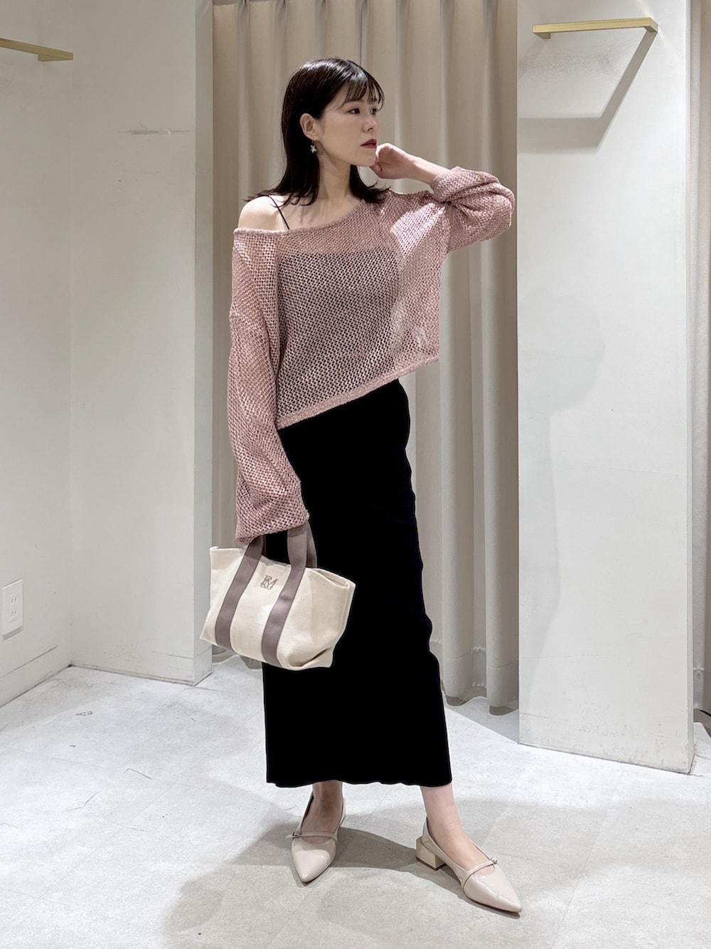 ピンク系のニット/セーター、ブラック系のキャミソール、グレー系のトートバッグを着用したレディースの春コーディネートの5枚目の写真