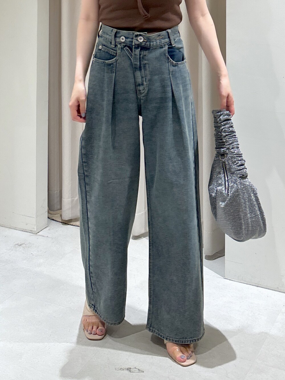 ブラウン系のTシャツ/カットソー、ブルー系のデニムパンツ、シルバー系のハンドバッグを着用したレディースの夏コーディネートの6枚目の写真