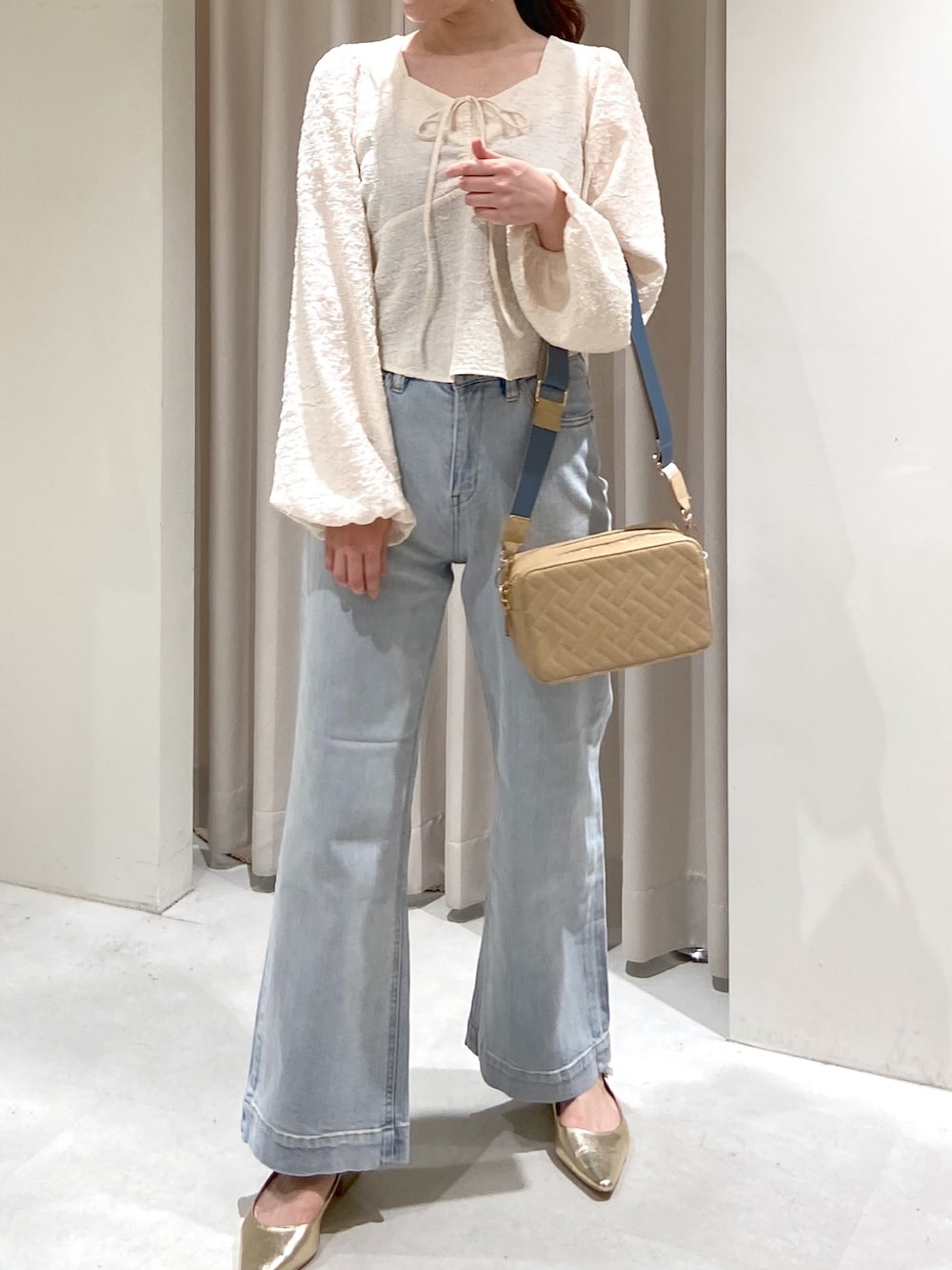 ホワイト系のシャツ/ブラウス、ブルー系のデニムパンツ、ベージュ系のボディバッグ/ウエストポーチを着用したレディースの春コーディネートの4枚目の写真