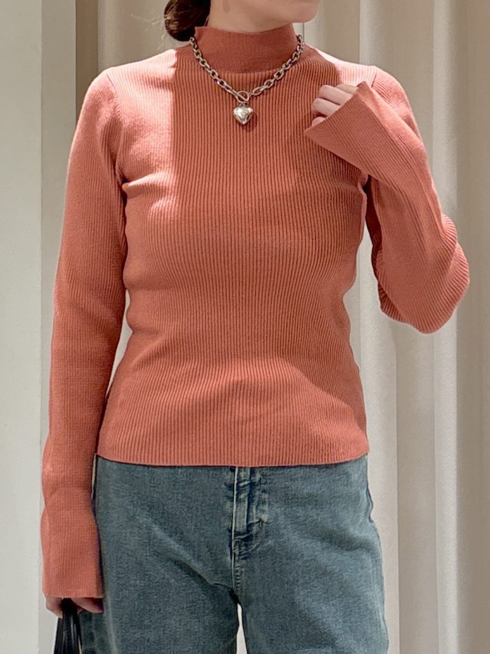 ブラウン系のシャツ/ブラウス、ピンク系のニット/セーター、ブラック系のトートバッグを着用したレディースの冬コーディネートの8枚目の写真