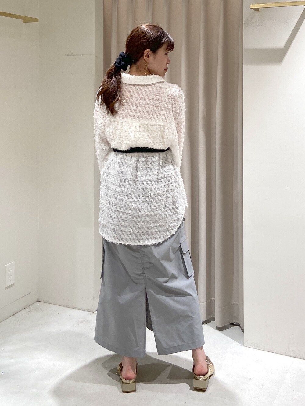 ブラック系のショルダーバッグ、ゴールド系のパンプス、ホワイト系のシャツ/ブラウスを着用したレディースの冬コーディネートの4枚目の写真