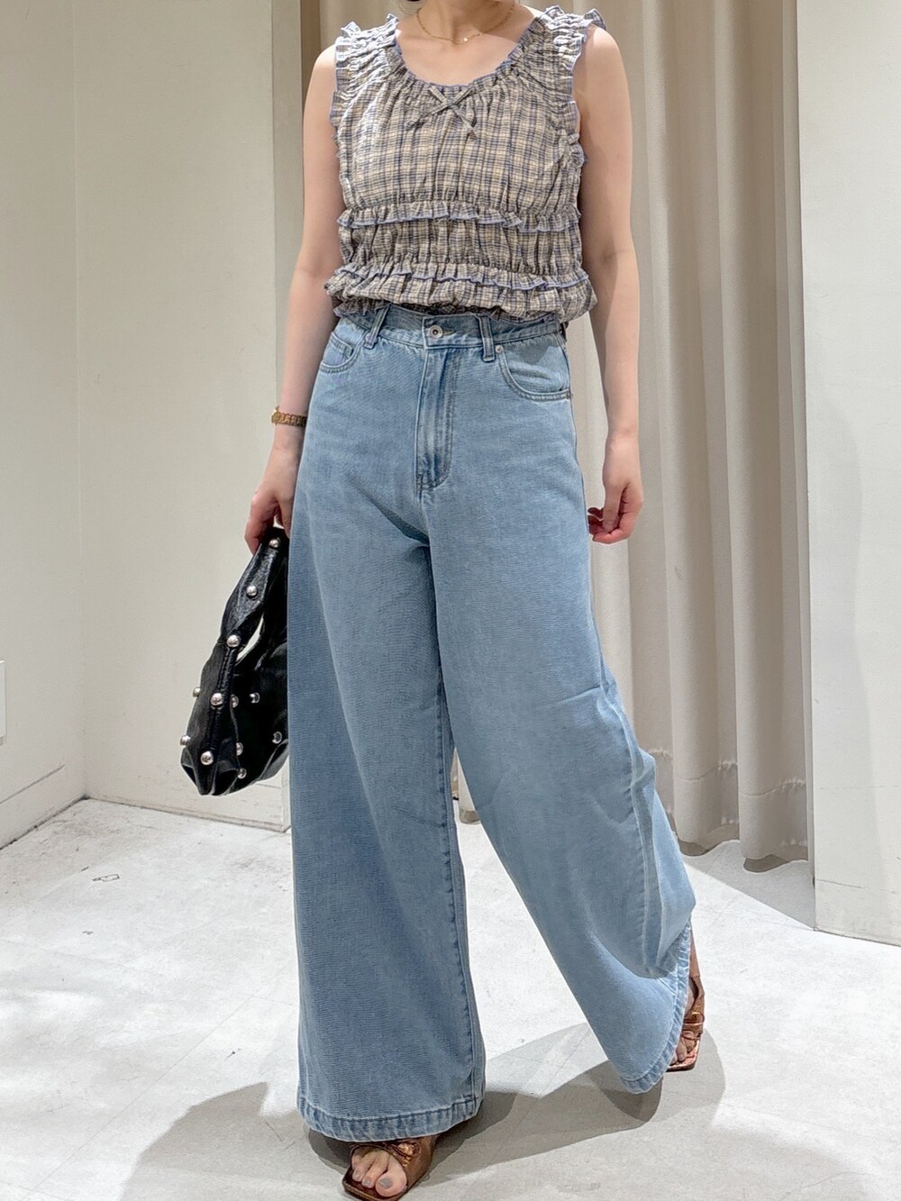 レッド系のシャツ/ブラウス、ブルー系のデニムパンツ、ブラック系のハンドバッグを着用したレディースの夏コーディネートの5枚目の写真