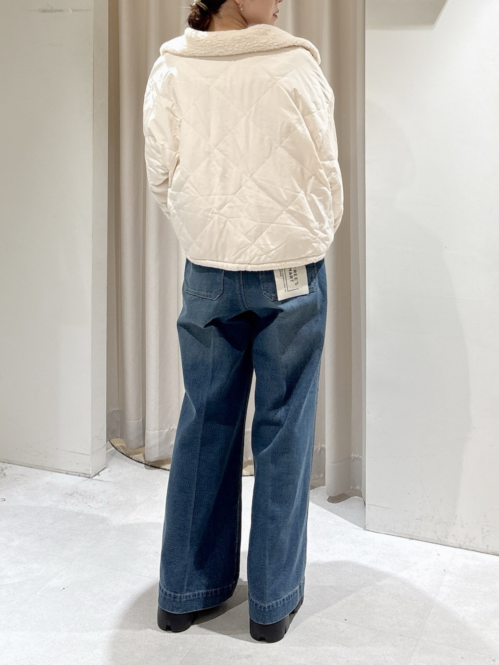 グレー系のニット/セーター、ブルー系のデニムパンツ、ホワイト系のトートバッグを着用したレディースの秋コーディネートの9枚目の写真