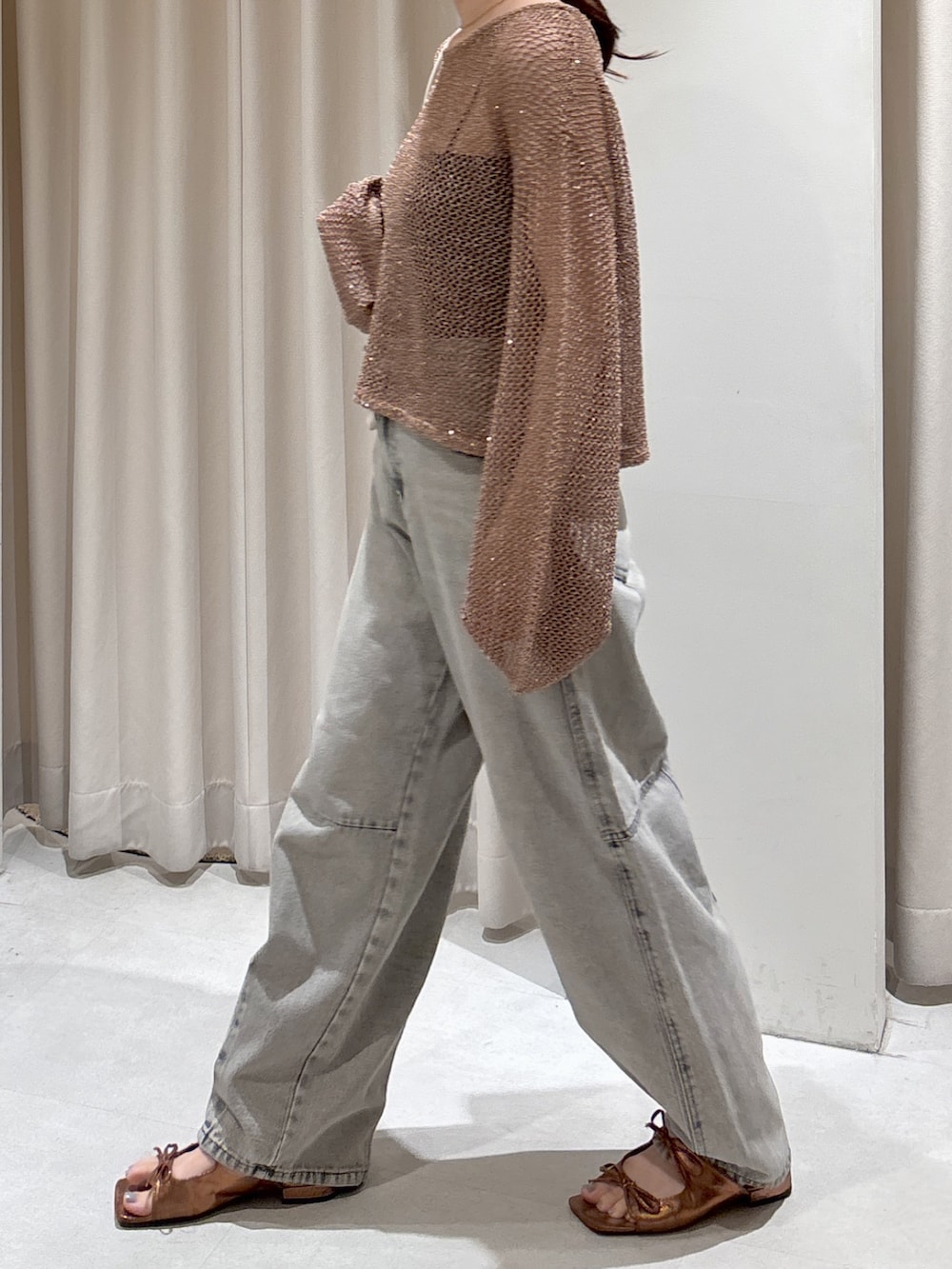 ブラウン系のニット/セーター、ブラック系のキャミソール、グレー系のデニムパンツを着用したレディースの秋コーディネートの3枚目の写真