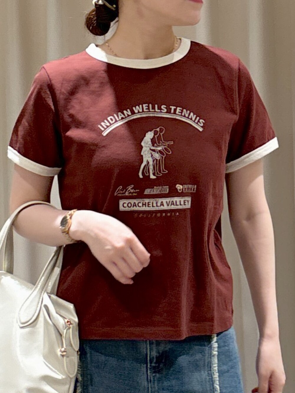 ブラウン系のTシャツ/カットソー、ホワイト系のボストンバッグ、ブルー系のスカートを着用したレディースの夏コーディネートの4枚目の写真