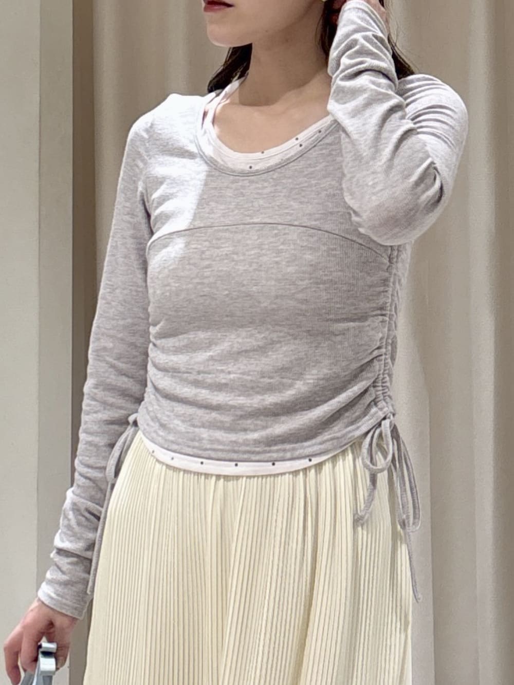 ベージュ系のテーラードジャケット、グレー系のTシャツ/カットソー、ホワイト系のスカートを着用したレディースの春コーディネートの6枚目の写真