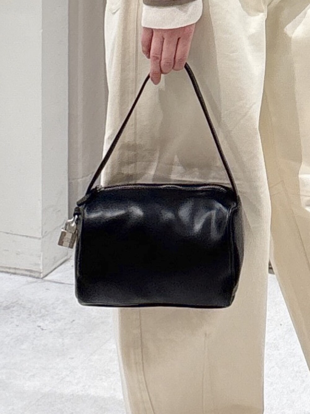 ブラウン系のニット/セーター、ホワイト系のその他パンツ、ブラック系のサンダルを着用したレディースの春コーディネートの7枚目の写真