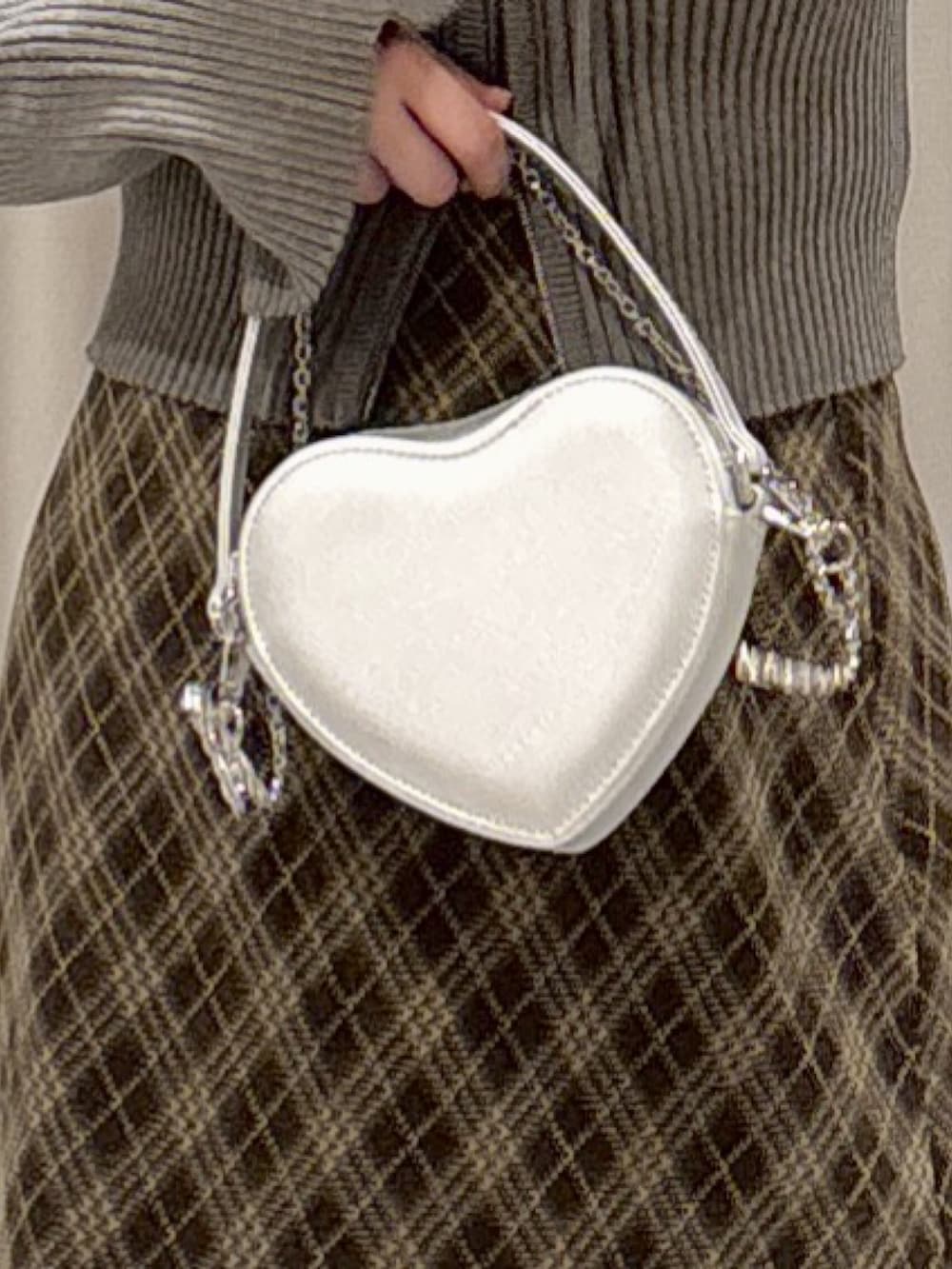 ブラウン系のニット/セーター、ブラウン系のスカート、シルバー系のショルダーバッグを着用したレディースの冬コーディネートの6枚目の写真