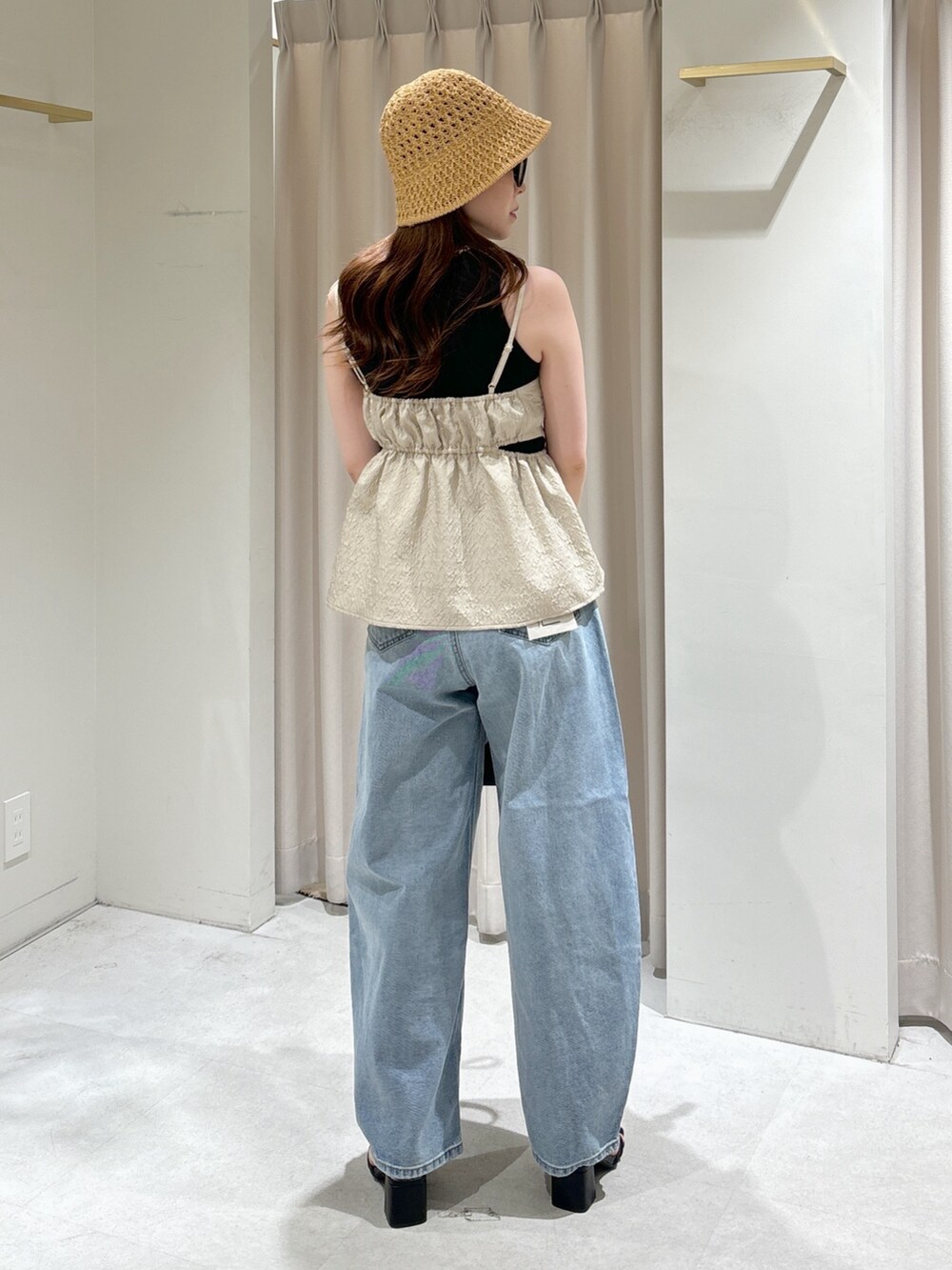 ホワイト系のシャツ/ブラウス、ブラック系のショルダーバッグ、ブルー系のデニムパンツを着用したレディースの夏コーディネートの6枚目の写真