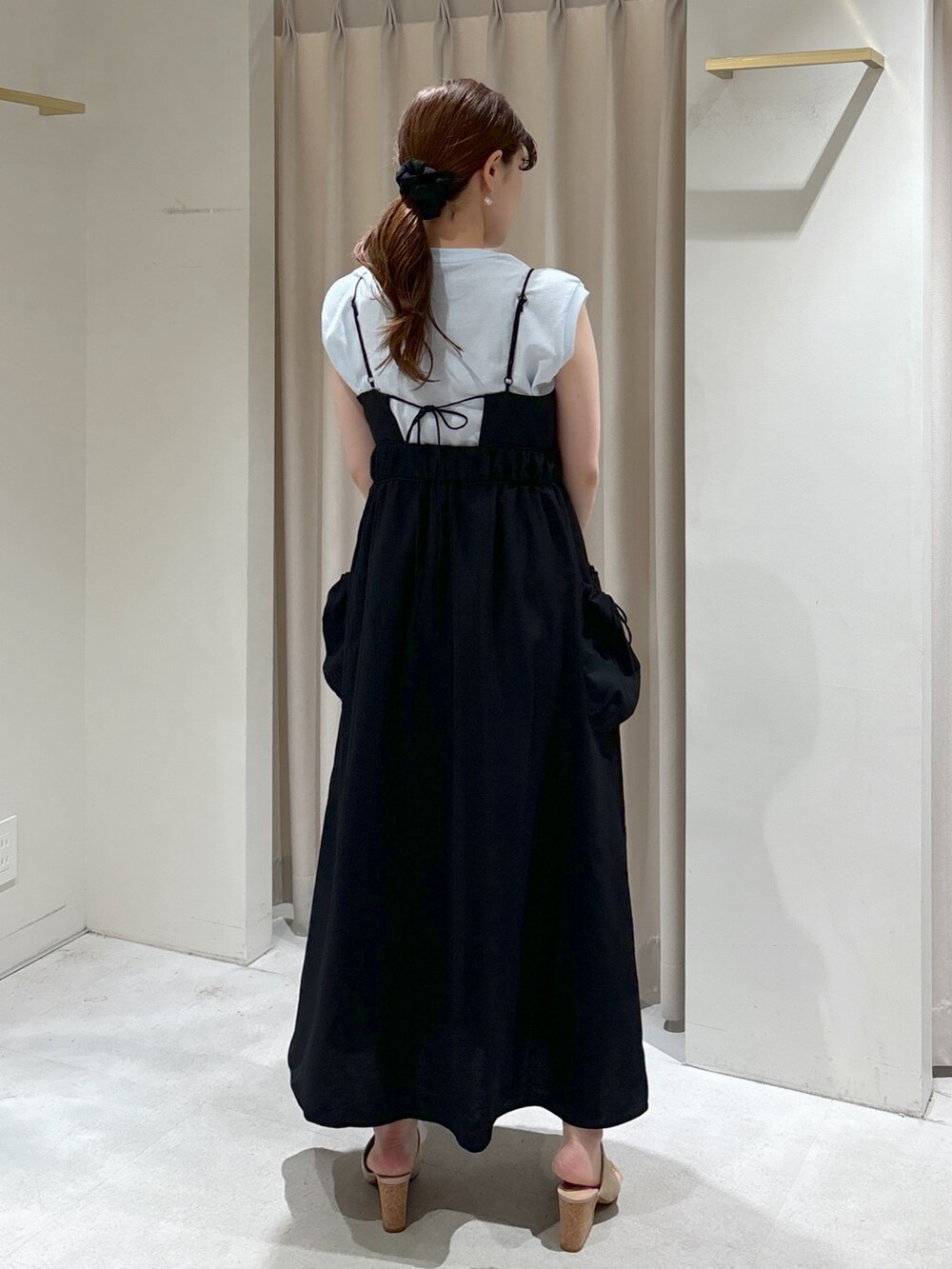 ブラック系のワンピース、グレー系のサンダル、ホワイト系のハンドバッグを着用したレディースの春コーディネートの3枚目の写真