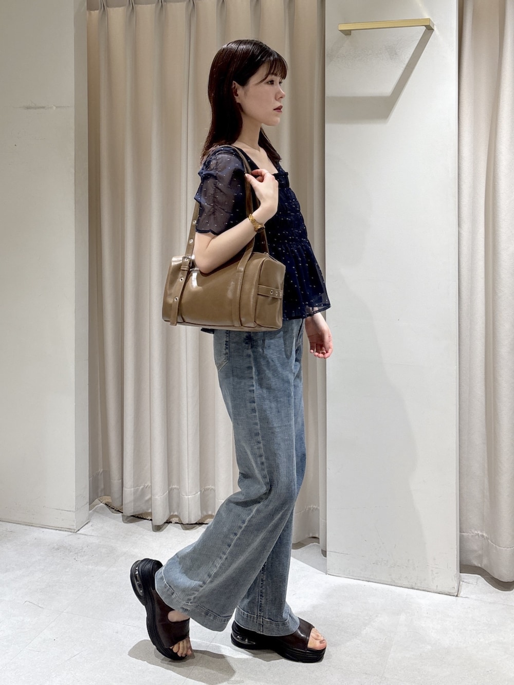 ブルー系のシャツ/ブラウス、ブルー系のデニムパンツ、ブラウン系のショルダーバッグを着用したレディースの夏コーディネートの5枚目の写真
