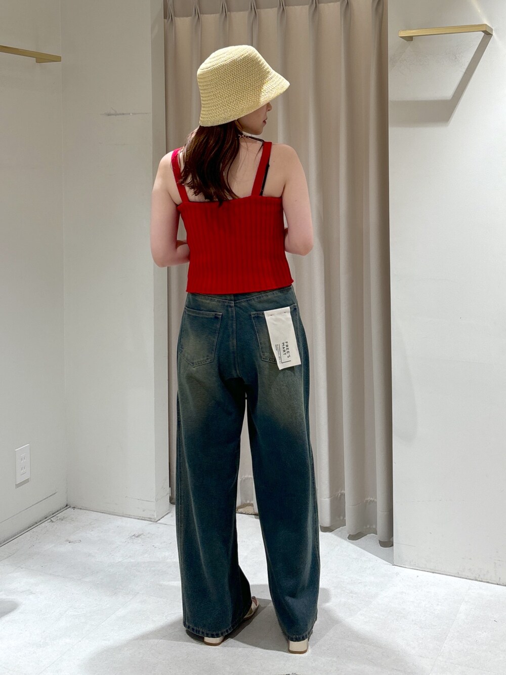 レッド系のタンクトップ、ブルー系のデニムパンツ、グレー系のショルダーバッグを着用したレディースの夏コーディネートの7枚目の写真