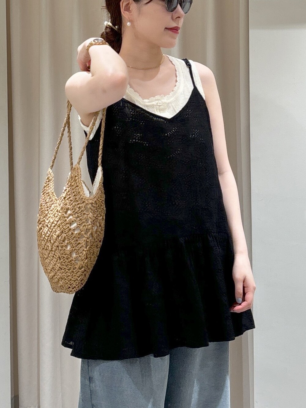 ブラック系のシャツ/ブラウス、ホワイト系のニット/セーター、ベージュ系のトートバッグを着用したレディースの春コーディネートの10枚目の写真