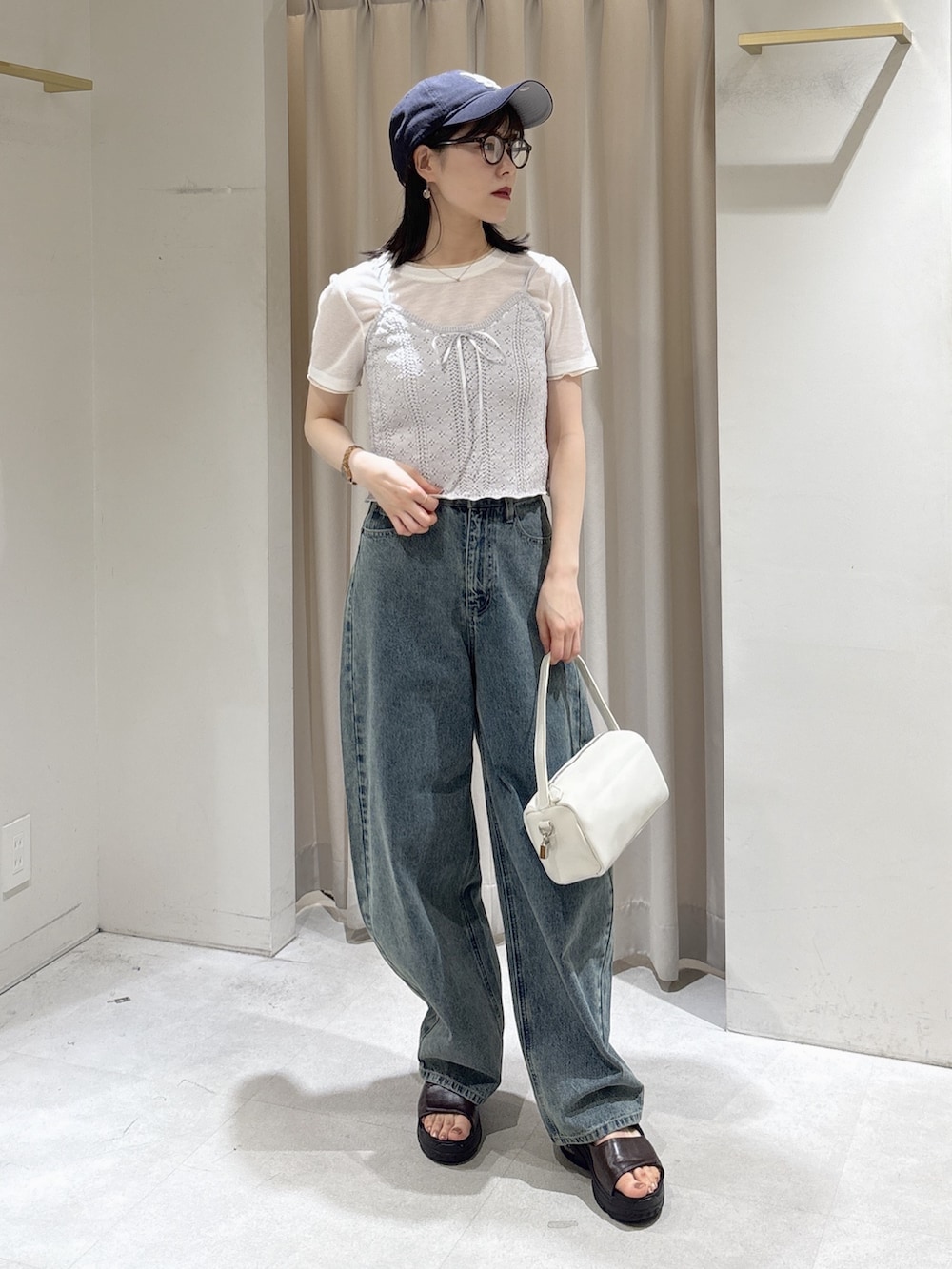 パープル系のニット/セーター、ホワイト系のTシャツ/カットソー、ホワイト系のハンドバッグを着用したレディースの夏コーディネートの2枚目の写真