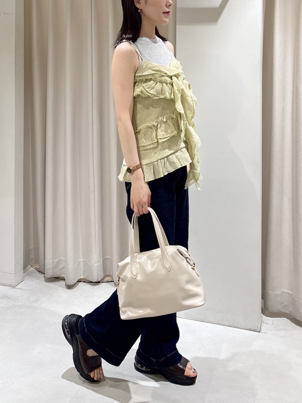 イエロー系のシャツ/ブラウス、グレー系のTシャツ/カットソー、ブラウン系のサンダルを着用したレディースの夏コーディネートの2枚目の写真