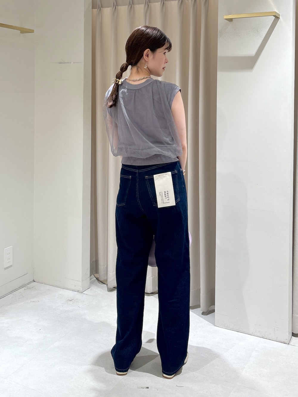 グレー系のベスト、ブルー系のデニムパンツ、ピンク系のシャツ/ブラウスを着用したレディースの夏コーディネートの2枚目の写真