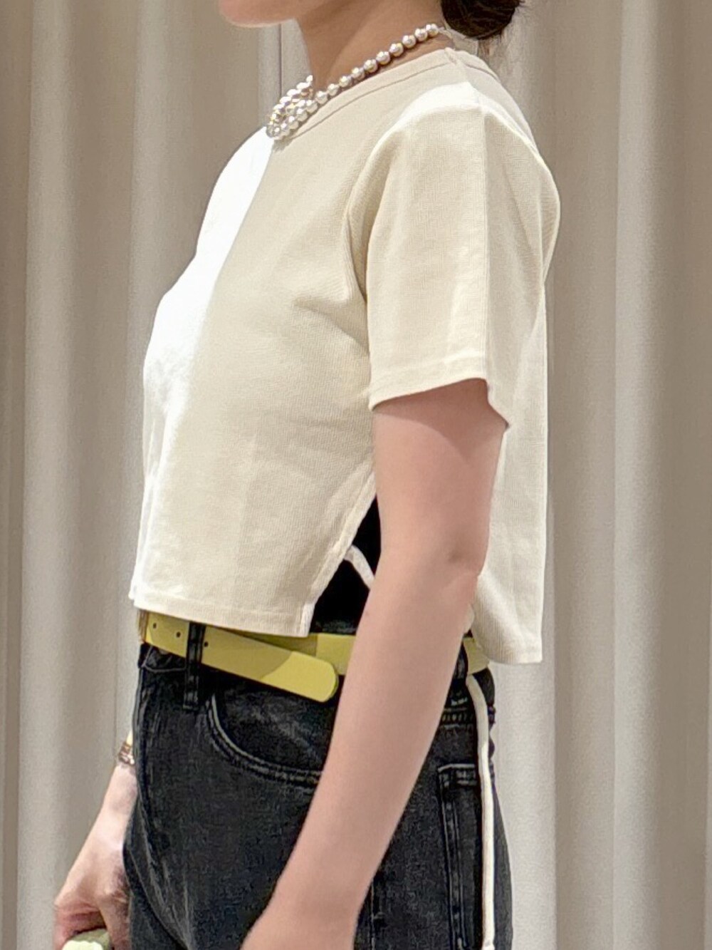 ホワイト系のTシャツ/カットソー、ブラック系のキャミソール、ブラック系のデニムパンツを着用したレディースの秋コーディネートの6枚目の写真