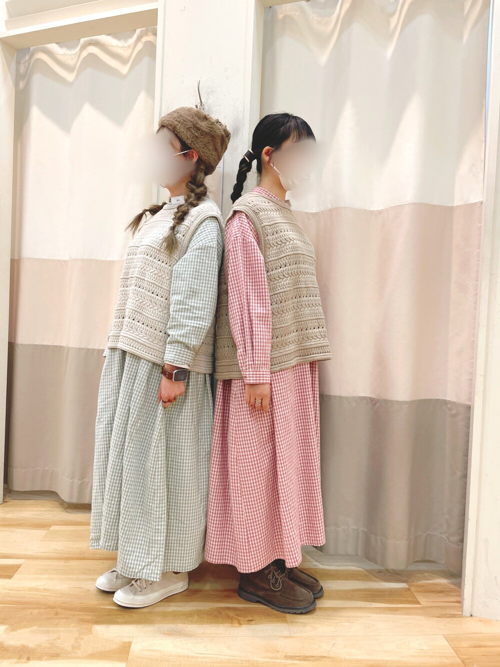 ベージュ系のブーツ、ピンク系のワンピース、ホワイト系のベストを着用したレディースの冬コーディネートの3枚目の写真