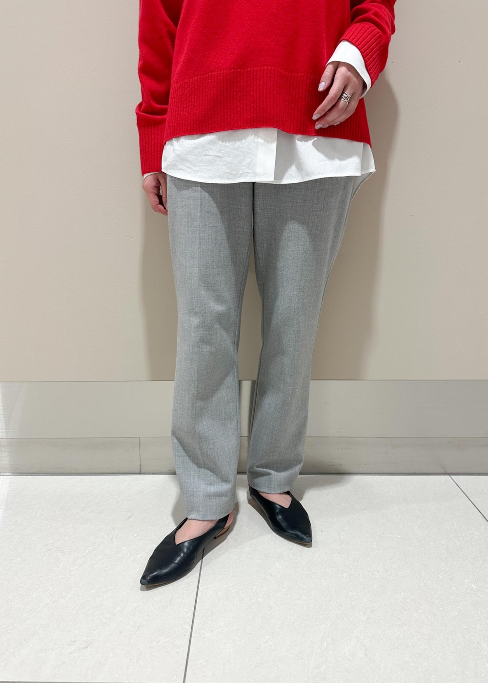 ブラック系のトートバッグ、ホワイト系のシャツ/ブラウス、レッド系のニット/セーターを着用したレディースの冬コーディネートの6枚目の写真