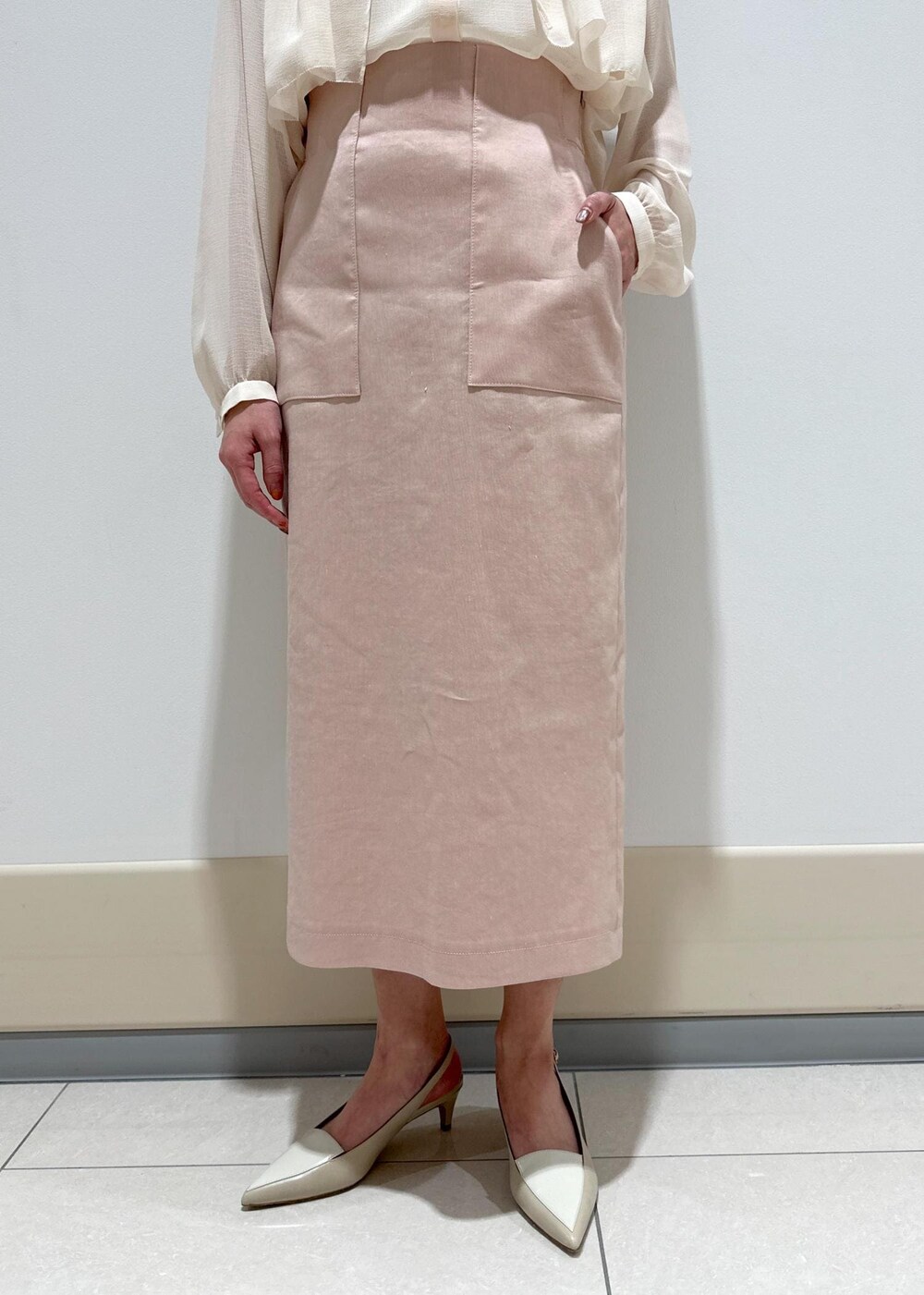 ブルー系のトートバッグ、ベージュ系のパンプス、ホワイト系のシャツ/ブラウスを着用したレディースの春コーディネートの7枚目の写真