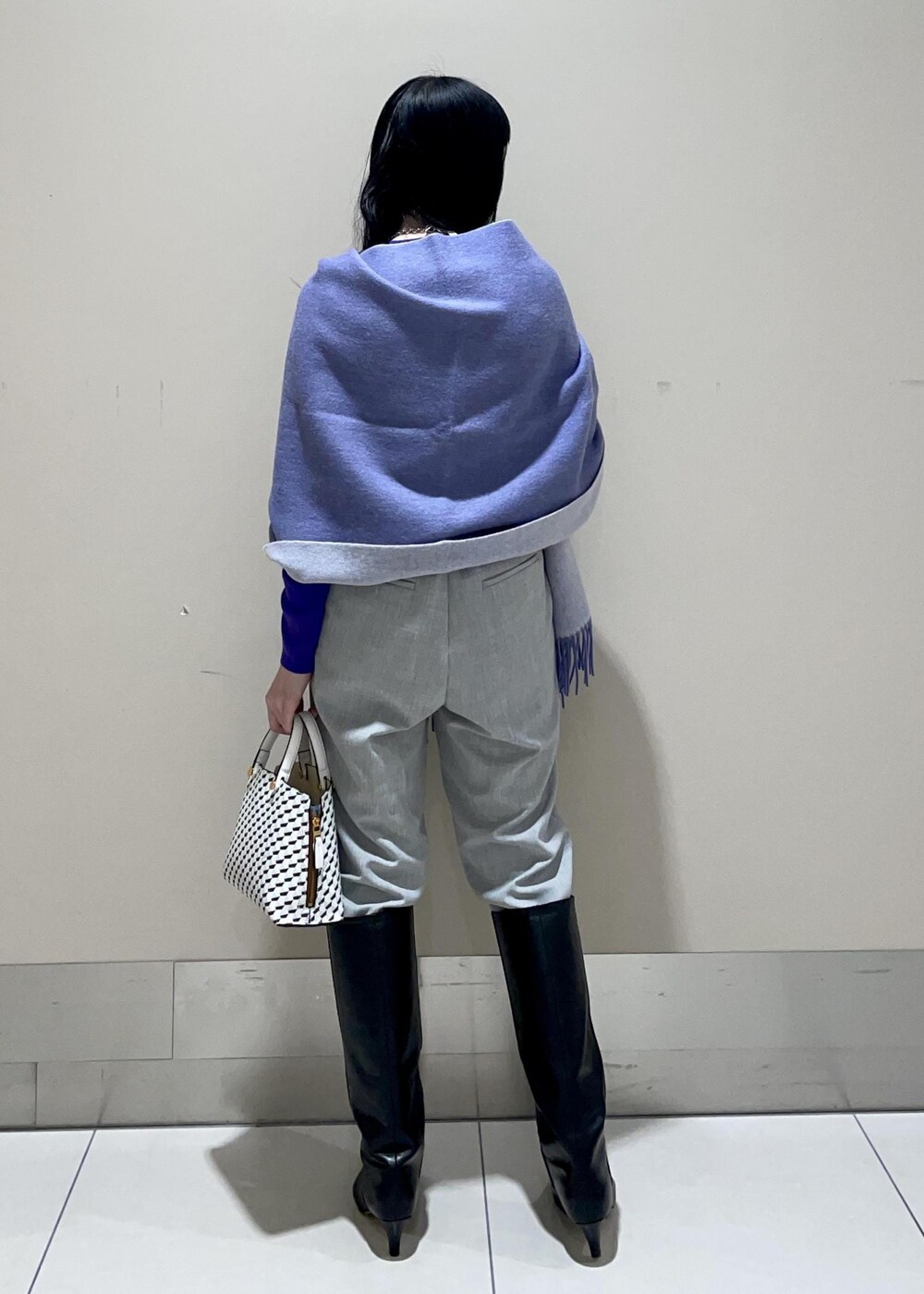 ホワイト系のショルダーバッグ、ブラック系のブーツ、グレー系のその他パンツを着用したレディースの冬コーディネートの3枚目の写真