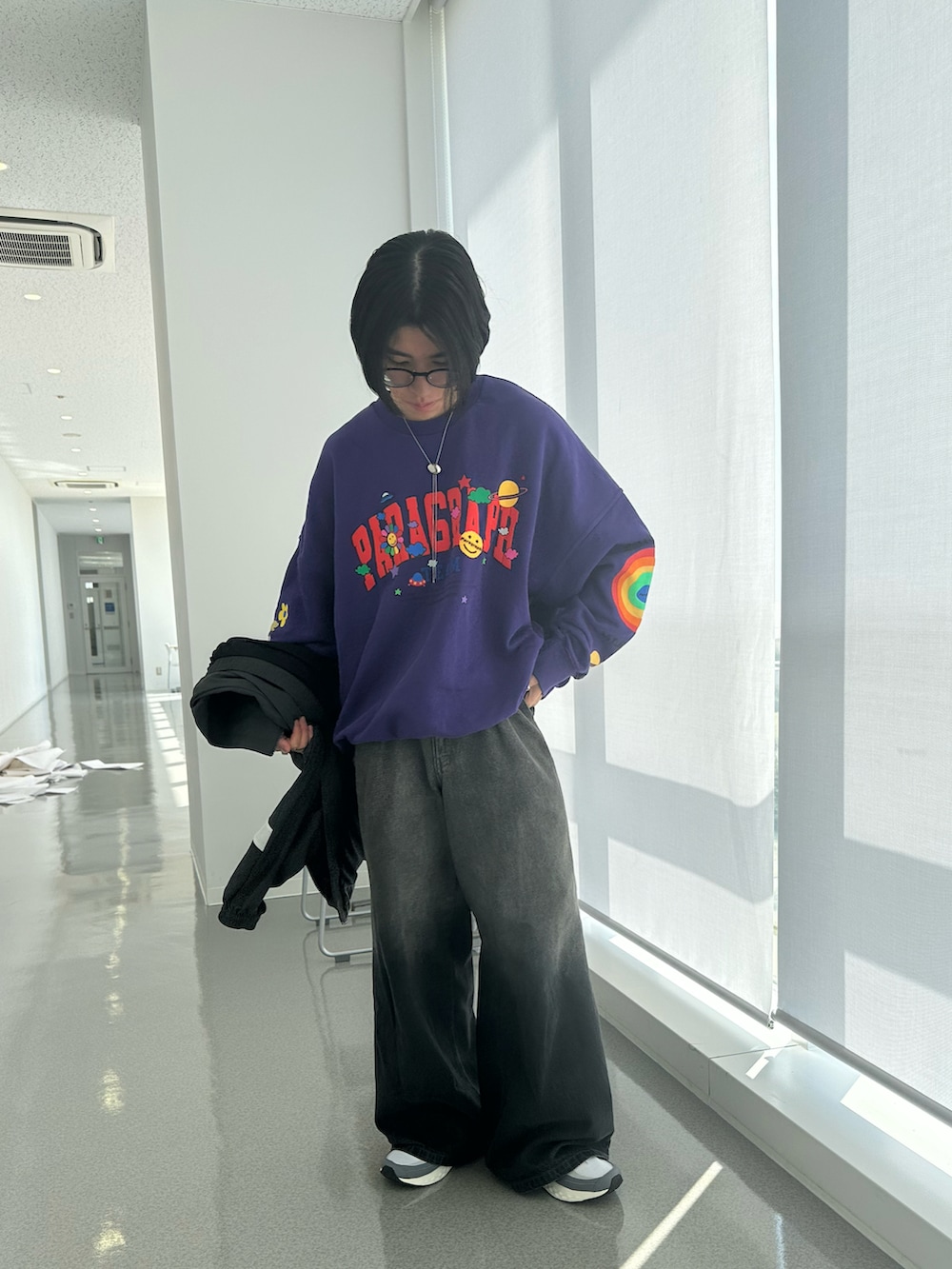 パープル系のスウェット、ブラック系のデニムパンツ、シルバー系のネックレスを着用したメンズの春コーディネートの3枚目の写真