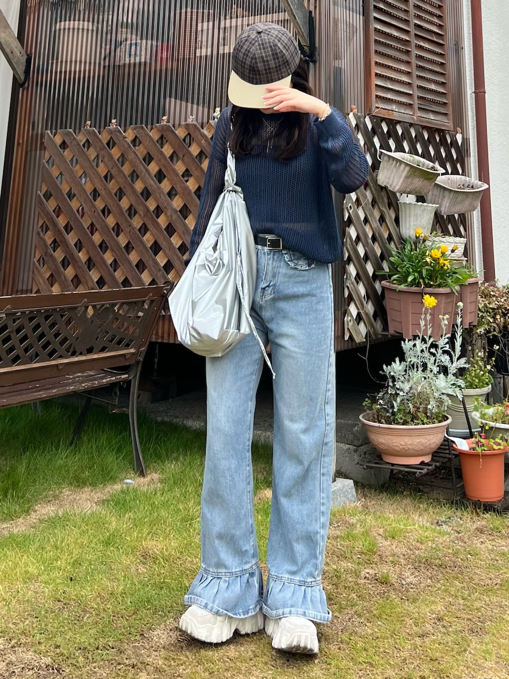 ブルー系のデニムパンツ、ホワイト系のスニーカー、ブルー系のトップスを着用したレディースの夏コーディネートの3枚目の写真