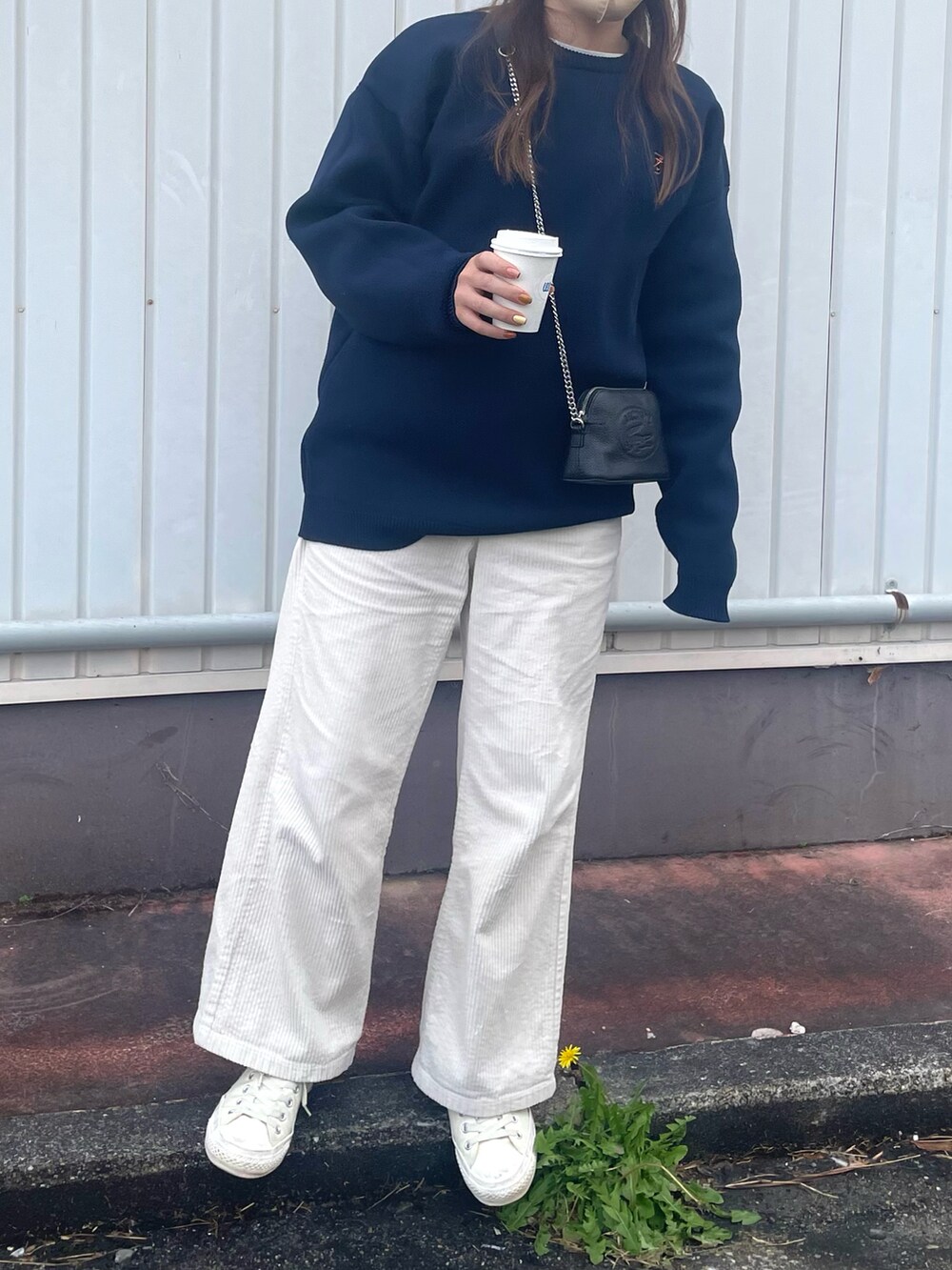 ブルー系のニット/セーター、ホワイト系のパンツ、ブラック系のショルダーバッグを着用したレディースの冬コーディネートの3枚目の写真