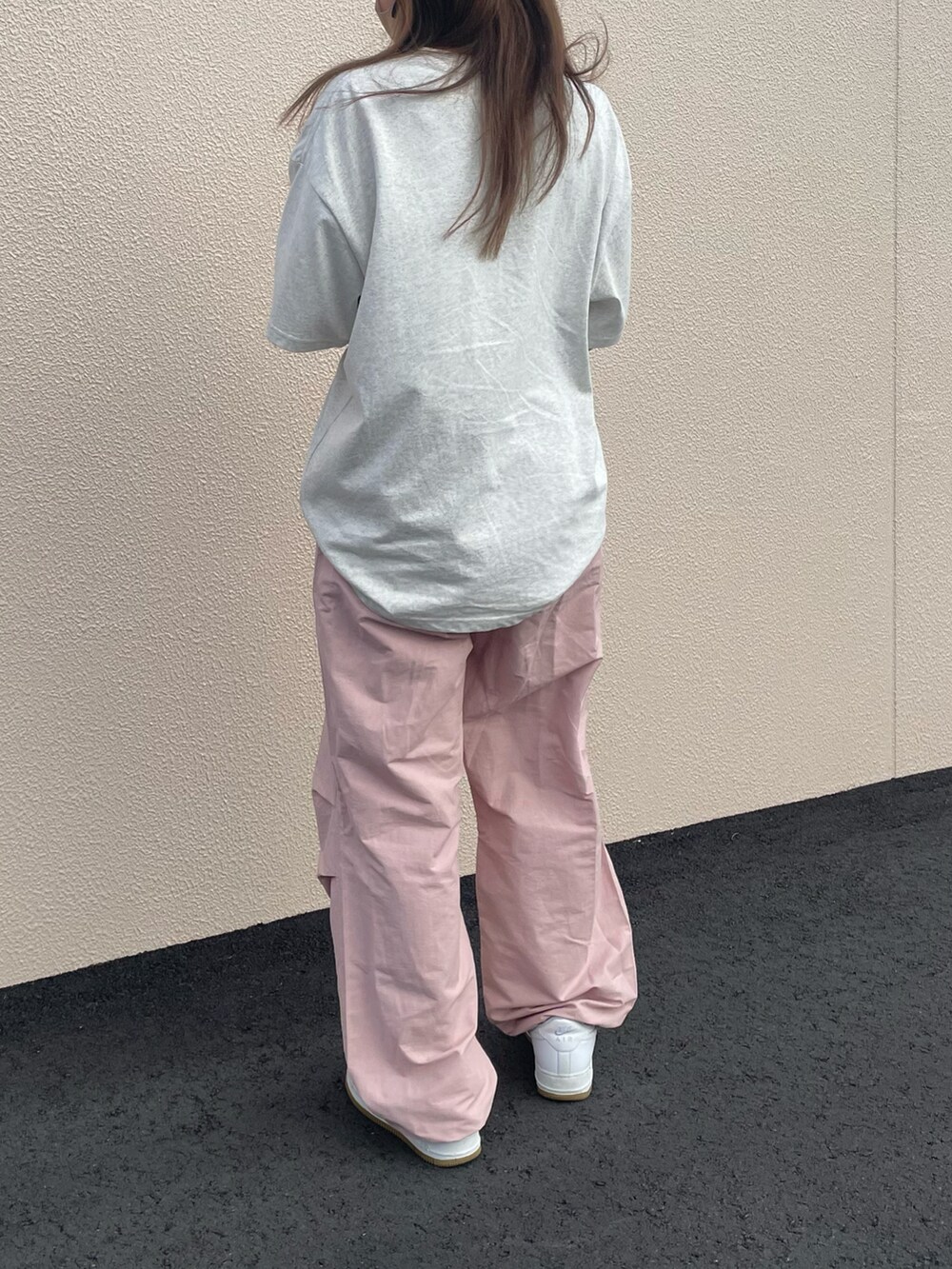 ピンク系のカーゴパンツ、ホワイト系のスニーカー、ベージュ系のTシャツ/カットソーを着用したレディースの夏コーディネートの3枚目の写真